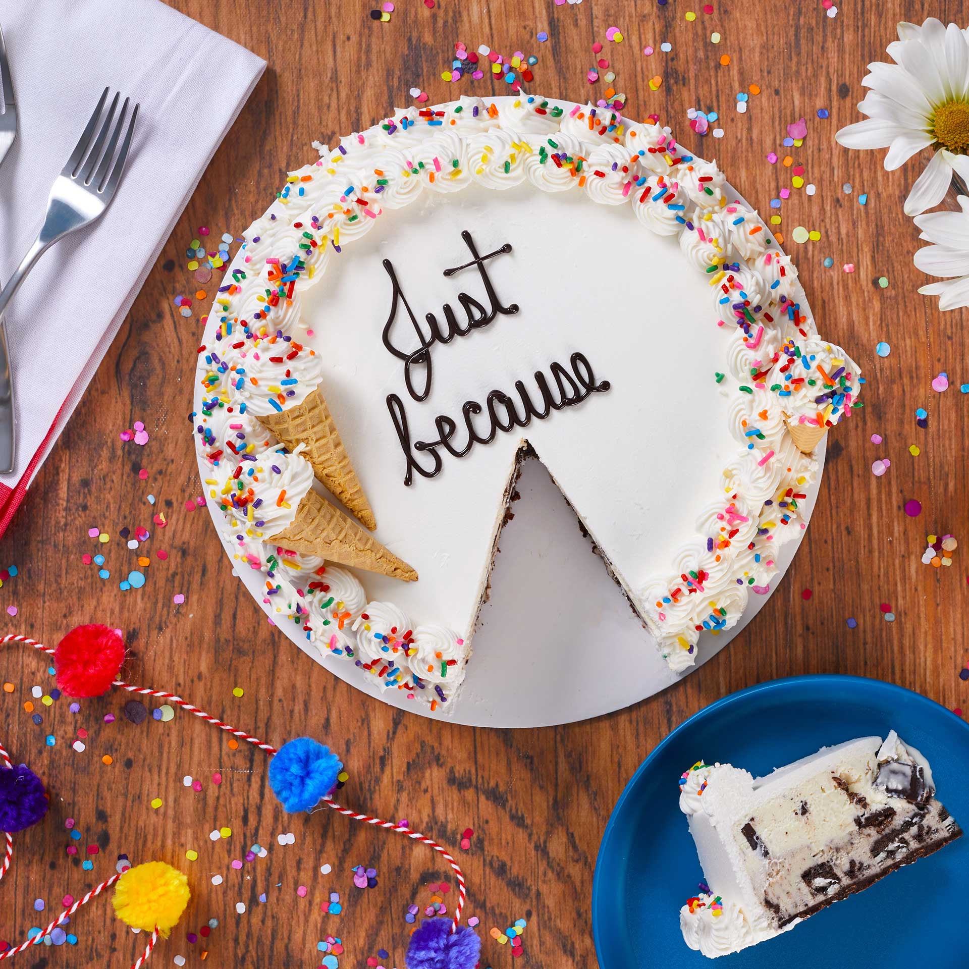 Ice cream cake with a slice laying on a plate next to the cake